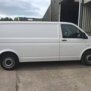 white vw camper entering garage