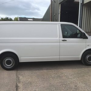 white vw camper entering garage