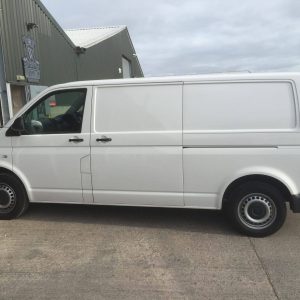 white vw camper entering garage