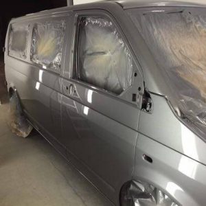 grey camper van being paint sprayed