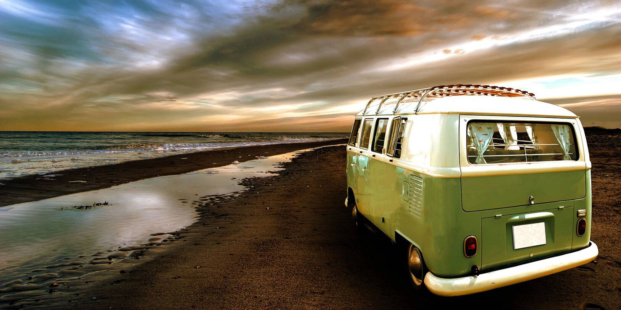 green vw campervan on beach