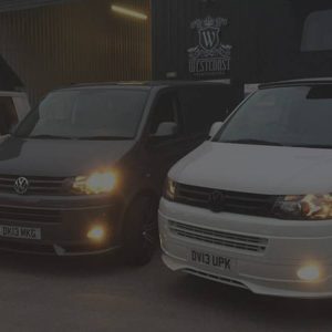 t5 vans lined up outside garage